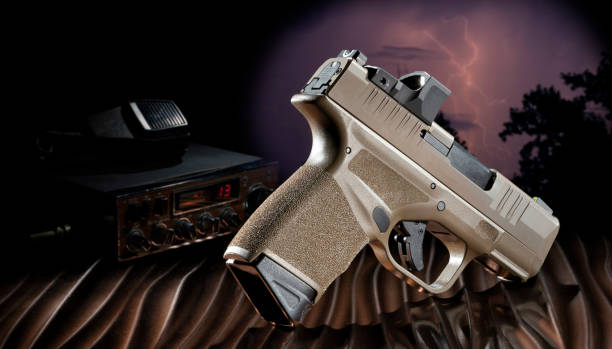istock 9 mm handgun and CB radio with lightning behind 1442736561