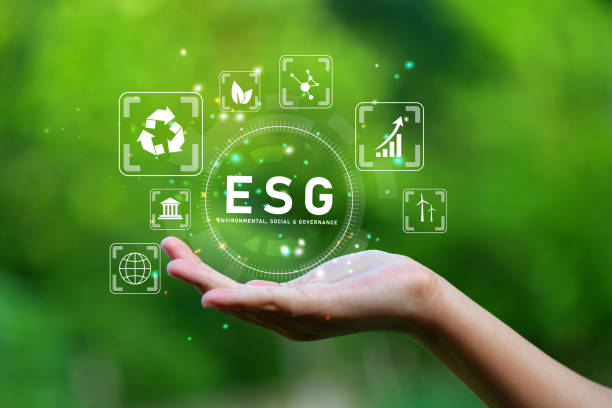 ESG icon concept in the hand for environmental, social and governance in sustainable and ethical business on network connections on green background. stock photo