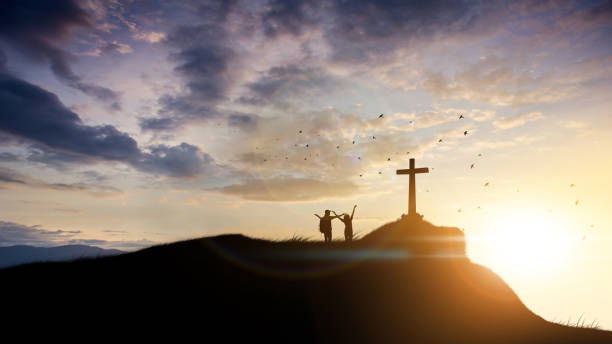 Family worship concept: a family at the Cross of Jesus. stock photo