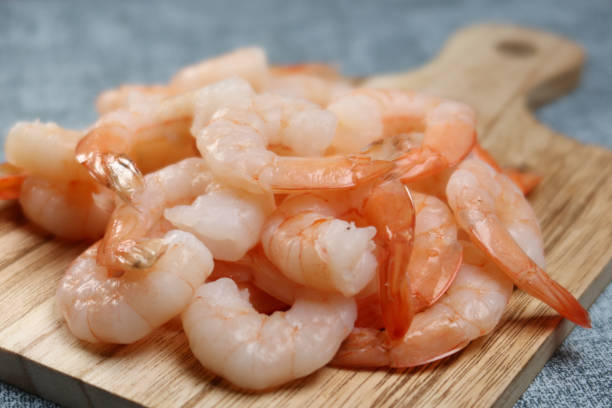istock close up of raw shrimp prawn on table. 1442744740