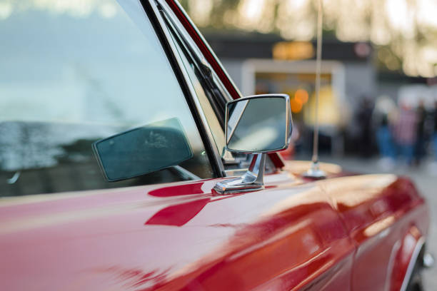 Izmir, Turkey - June 21, 2021: Close up shot of a Peugeot 204 red car side mirror which produced in France between 1965 and 1976 years. Editorial Shot in Izmir Turkey.