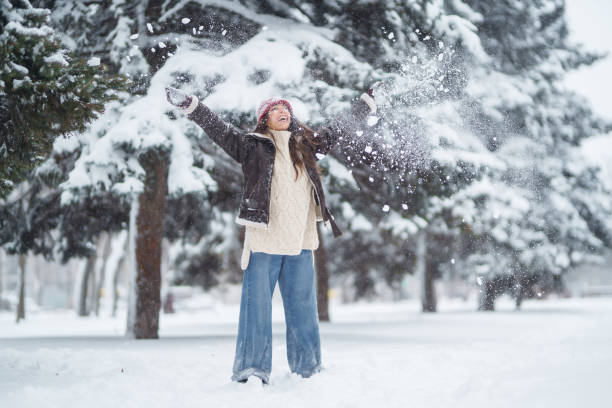 istock Happy woman  enjoying first snow in the forest. 1442748112