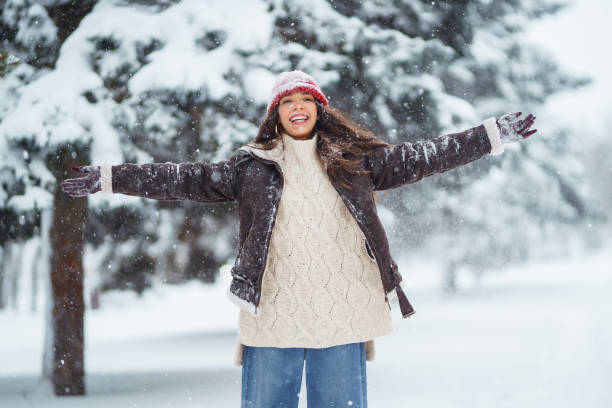 istock Happy woman  enjoying first snow in the forest. 1442748129