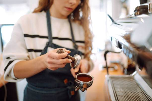 istock Barista holding cup getting fresh coffee that being brewed by the machine in cafe. 1442748583