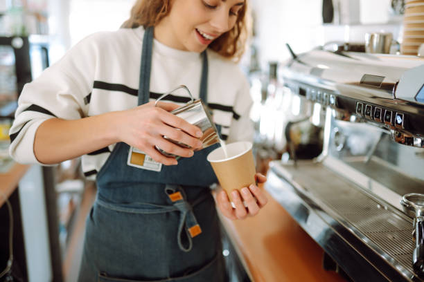 istock Barista holding cup getting fresh coffee that being brewed by the machine in cafe. 1442749127