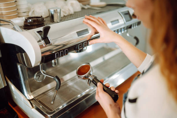 istock Barista holding cup getting fresh coffee that being brewed by the machine in cafe. 1442749137