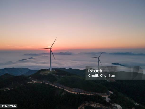 Cloudy Sea And Wind Power On Peaks At Sunrise Stock Photo - Download Image Now - Abstract, Agriculture, Atmospheric Mood
