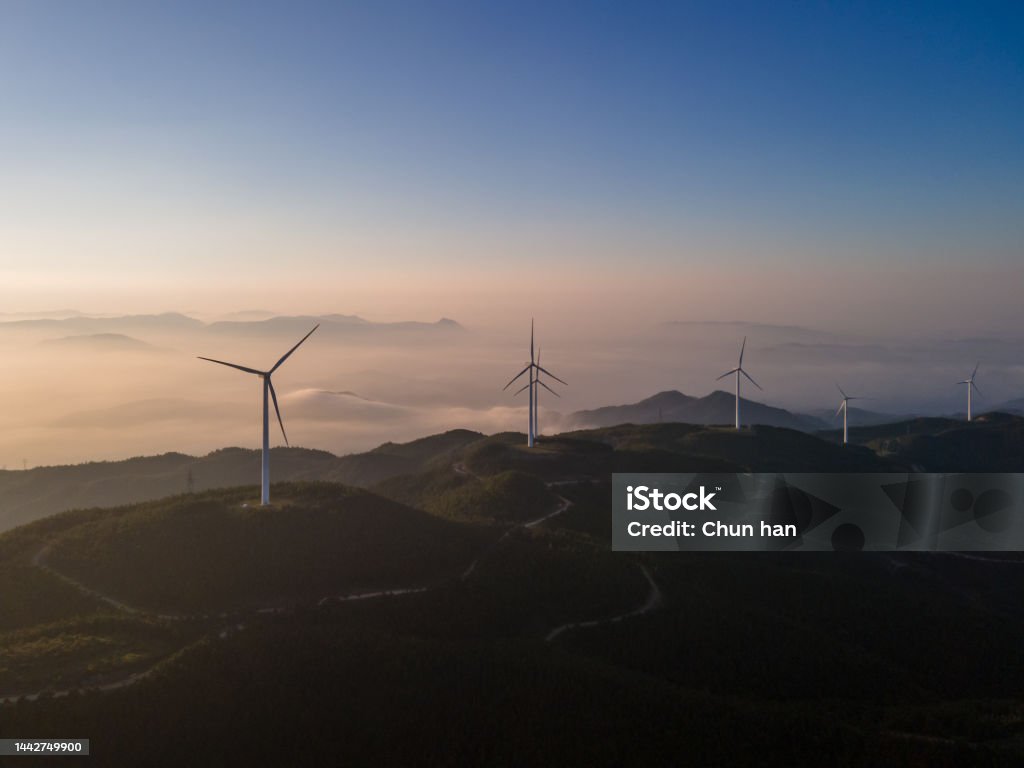Sea of Clouds and Wind Power Generators on the Mountain in the Early Morning Sustainable Resources Stock Photo