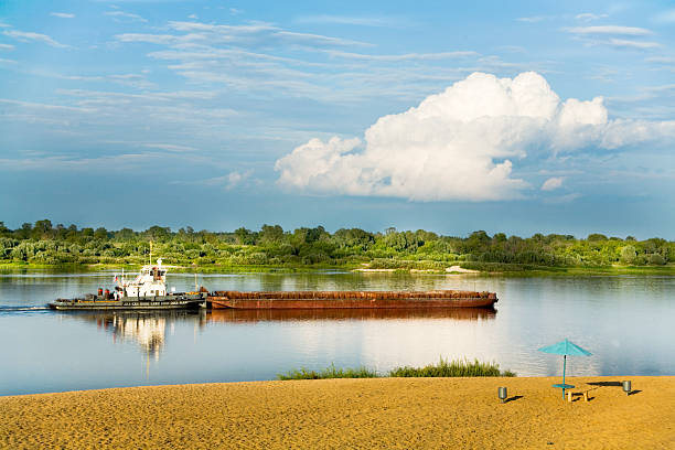 istock tugboat with barge on the river 144275133