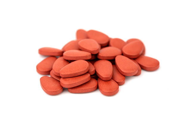 istock the red pills isolated on the white background 1442752946
