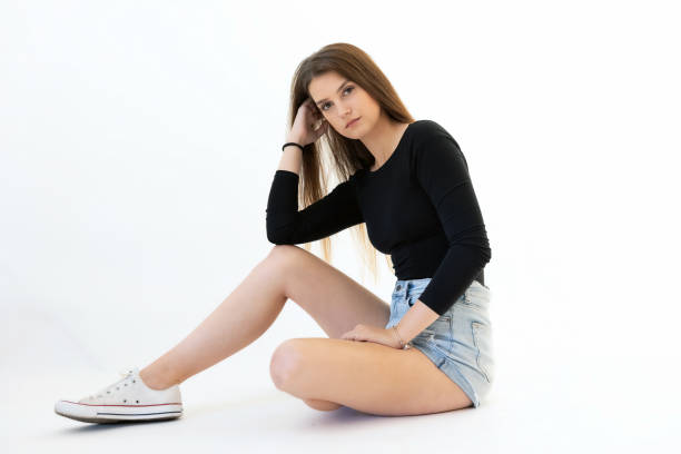 istock Young woman posing  sitting on floor. 1442757821