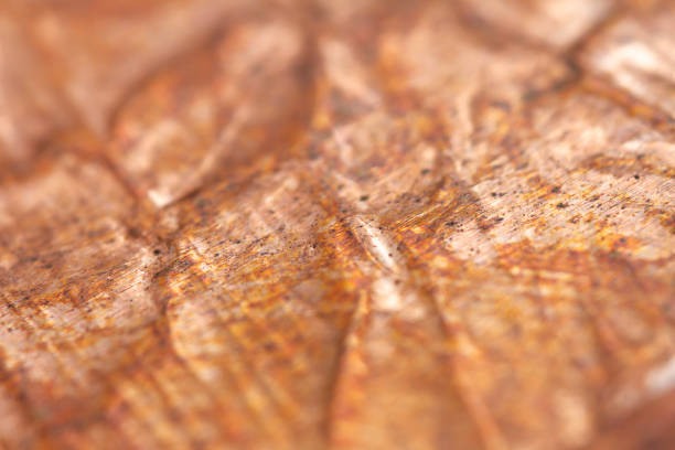 Extreme closeup of crumpled brass foil texture. Selective soft focus, shallow depth of field.