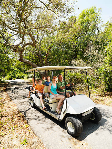Family in golf cart. stock photo