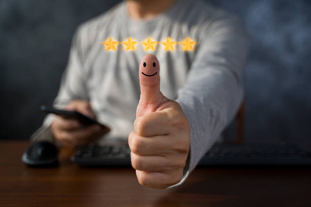 istock Hand with thumb up Positive emotion smiley face icon and five star with copy space, man using smartphone. 1442761829