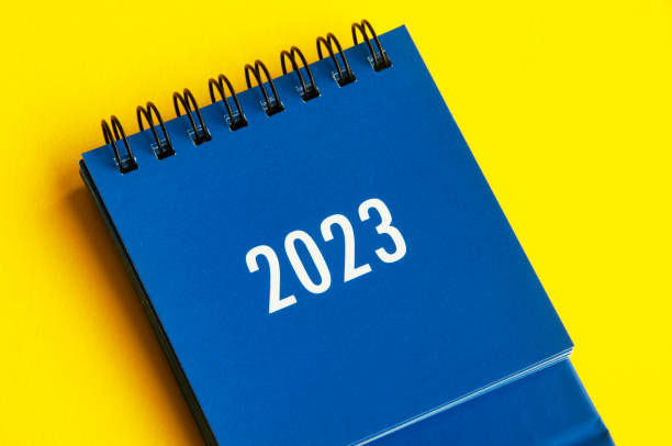 istock 2023 blue desk calendar on yellow cover background. 1442763301