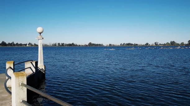istock Pier with railing and light fixture on the lake, blue sky, rafting 1442765297