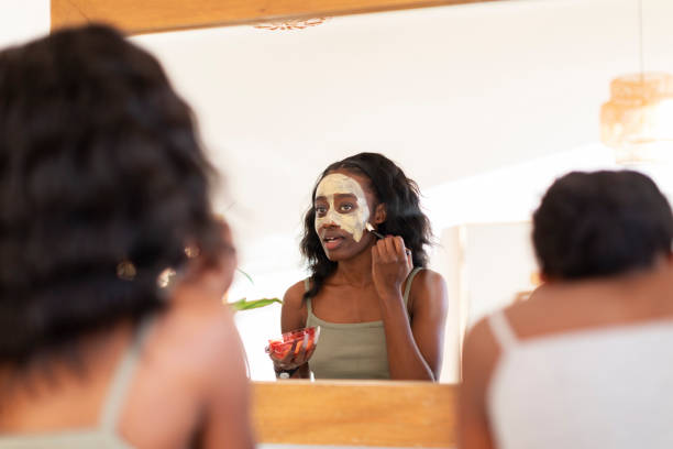 istock Two young African women doing mud therapy at home bathroom 1442765867