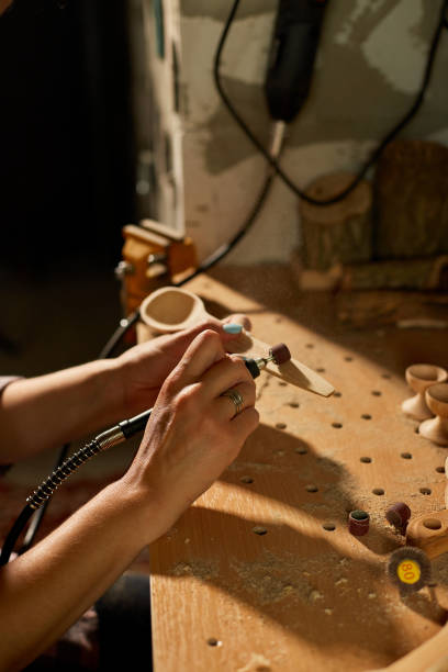 istock Female using power working tools graver for wooden utensils spoon 1442767224