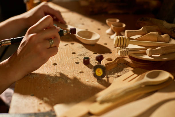 istock Female using power working tools graver for wooden utensils spoon 1442767234