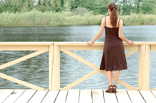 istock Woman standing at pier 144276736