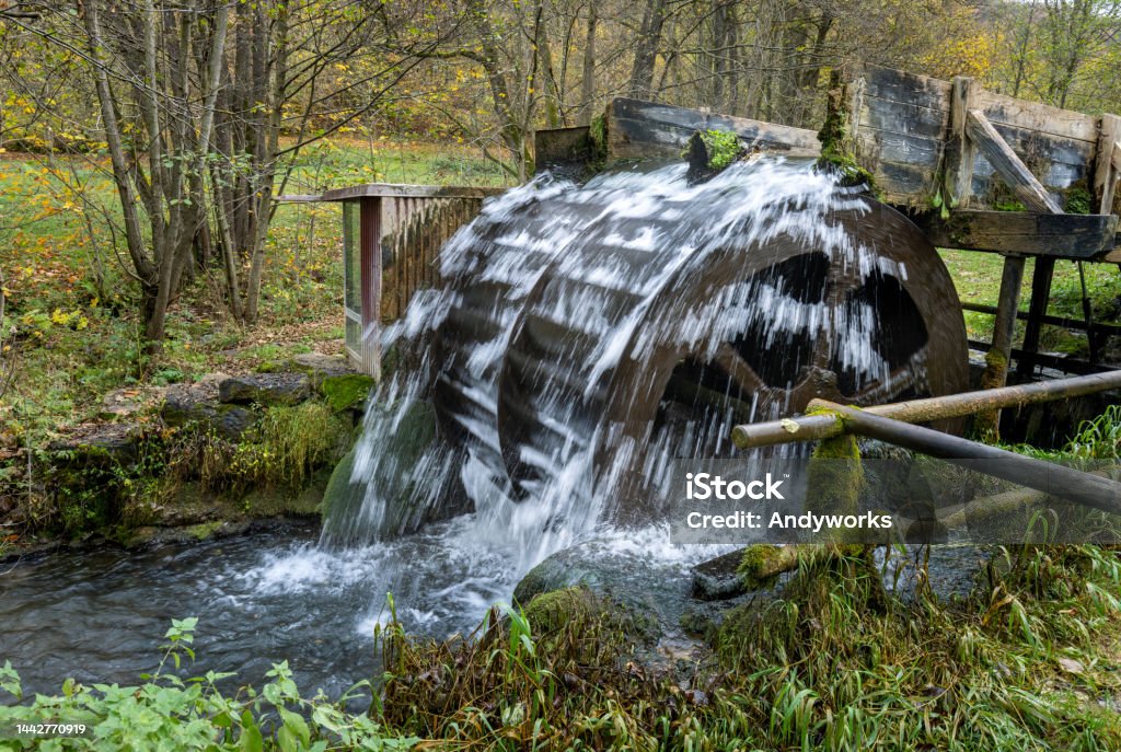 Old waterwheel in franconia, bavaria Old waterwheel set up in a stream producing energy. Watermill Stock Photo