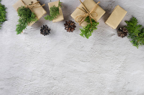 christmas still life. xmas gift in craft paper with pine cones, fir branches - new years eve christmas paper christmas fir tree imagens e fotografias de stock