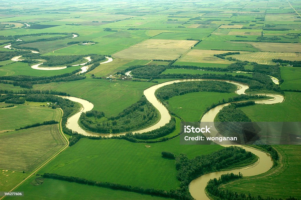Curved river from the top A top view of a curved river in northern alberta, canada. River Stock Photo