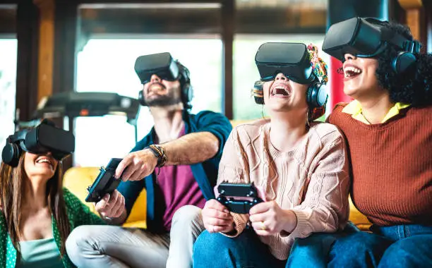 Room mate friends having fun with vr headset at home - Virtual reality and metaverse gaming concept with young people having fun on 3d videogames - Shape of technologic gears has been modified