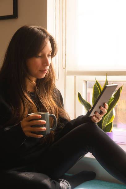 istock Woman at home reading ebook 1442776981