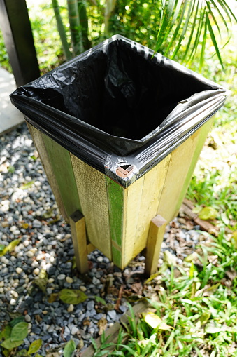 Wooden litter bin  in garden