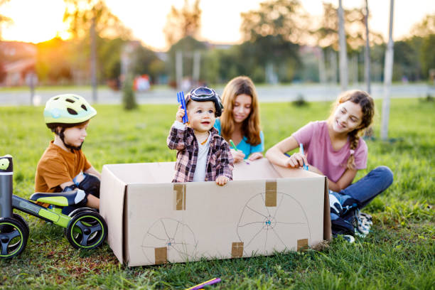 istock Children playing whit cardboard box in the nature 1442781293
