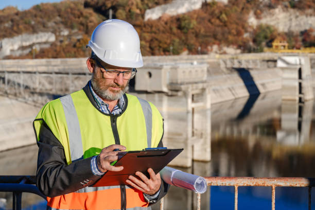 istock Male engineer working writing on a clipboard in hydroelectric dam 1442783455