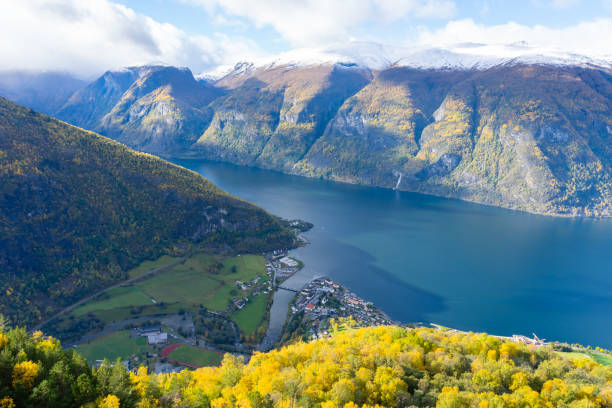 The Aurlandsfjord with a village and surrounding snow mountains view from the Stegastein viewing platform. Aurlandsfjord is a fjord in Vestland county, Norway. stegastein viewpoint stock pictures, royalty-free photos & images