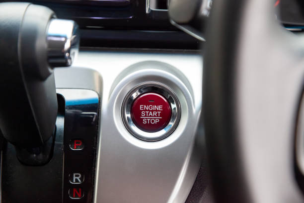 istock Red Button start and turn off the ignition of the car engine close-up on the dashboard, electric key, of modern design black and with elements chrome on the interior panel. Auto service industry. 1442784107