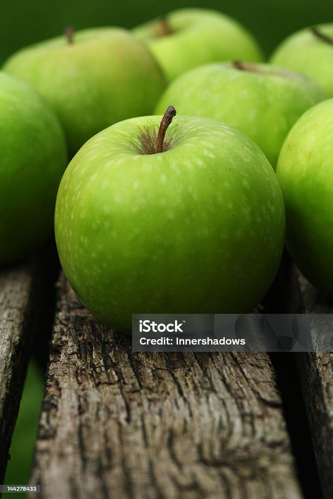 Close-up of Granny Smith apples Lots of green apples on a wooden bench Apple - Fruit Stock Photo