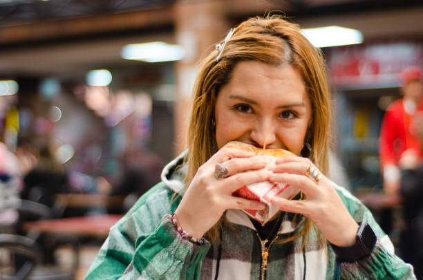 istock Woman eating hamburger with copy space 1442784980