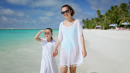 Woman With Child Daughter Together On Beach. Summer Vacation