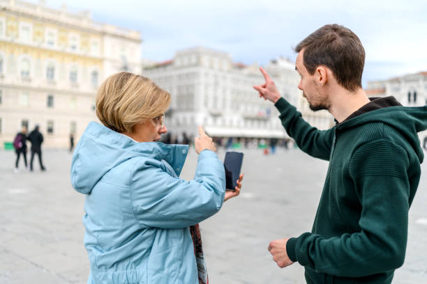 Tourist asking for help on the street Worried tourist asking for help to a boy on the street doing a favor stock pictures, royalty-free photos & images