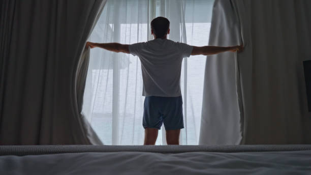 istock Person Opening Window Curtains In Morning To Get Day Light 1442785463