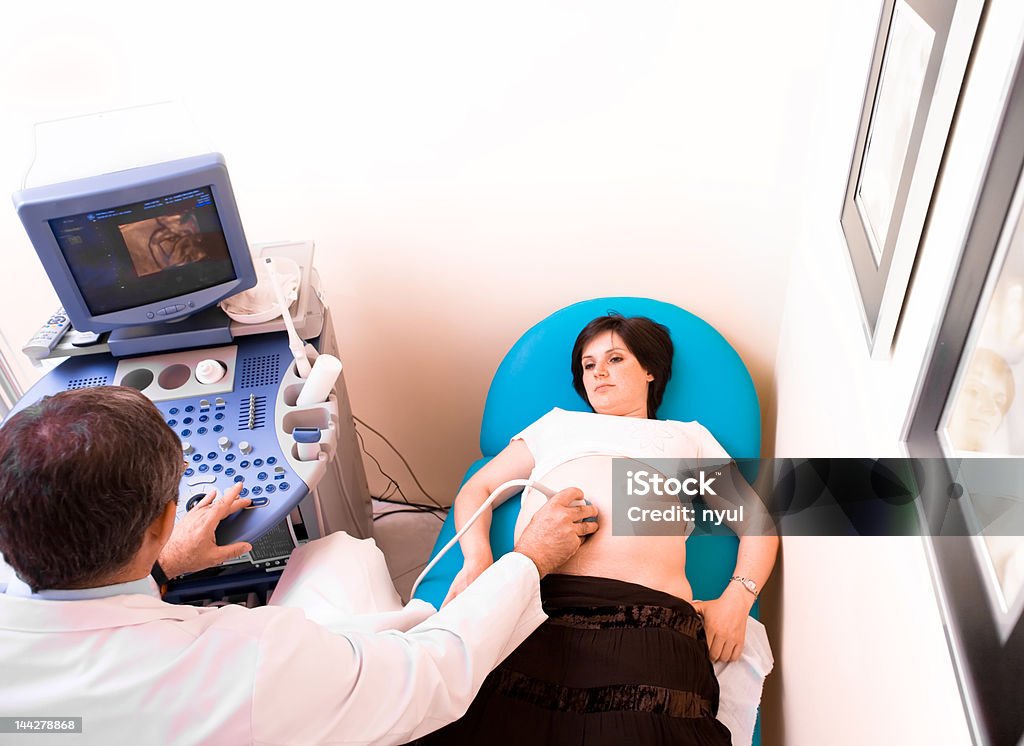 4D ultrasonic scan Obstetrician examining pregnant belly by 4D ultrasonic scan. 20-29 Years Stock Photo