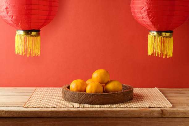 istock Chinese New Year celebration background with orange fruit on table and traditional red lanterns 1442790362