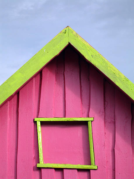 Funny house Very fuschia pink house with very yellow window and roof alintal stock pictures, royalty-free photos & images