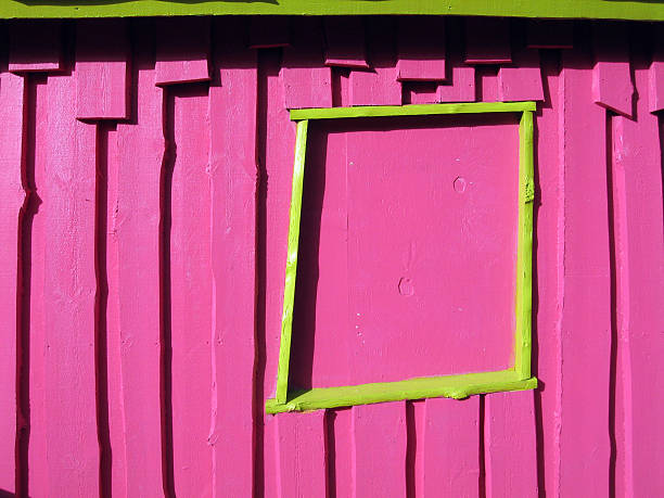 Window of the funny house Very pink wooden wall with very yellow window alintal stock pictures, royalty-free photos & images