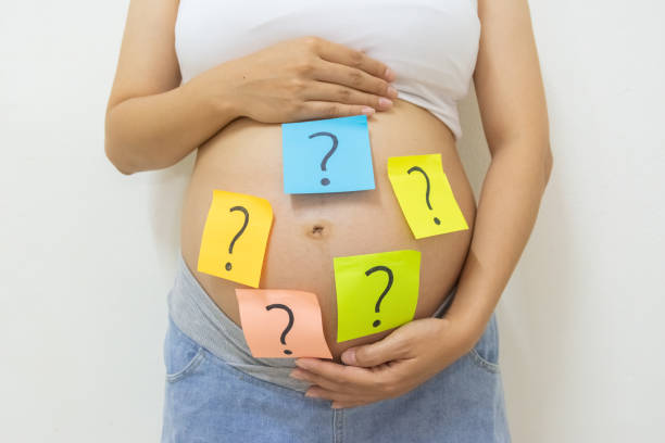 istock pregnant woman with question marks 1442792431