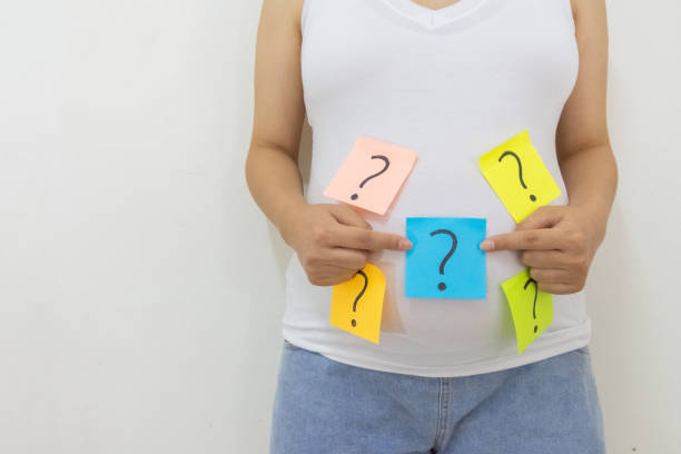 istock pregnant woman with question marks 1442792433