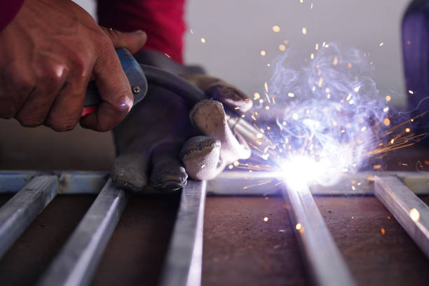 istock A male worker with close-up smoke and sparks. 1442792833