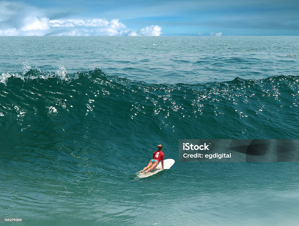 Surfing in the Pacific Ocean Young girl surfing on Malibu Beach, California Surfing Stock Photo