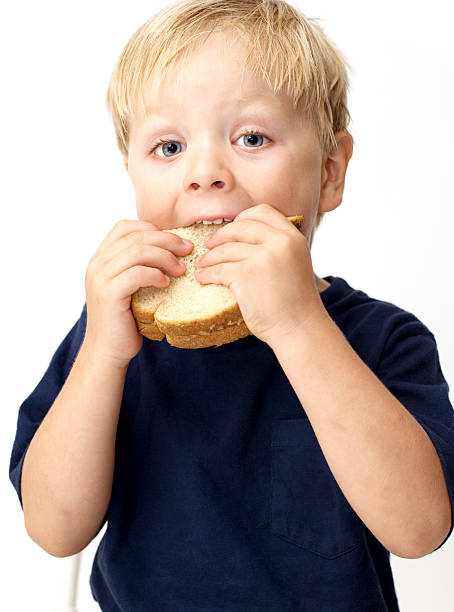 istock Boy eating peanut butter sandwich 144279443