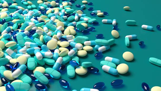 istock blue, green and yellow medicines scattered on a blue table 1442796977