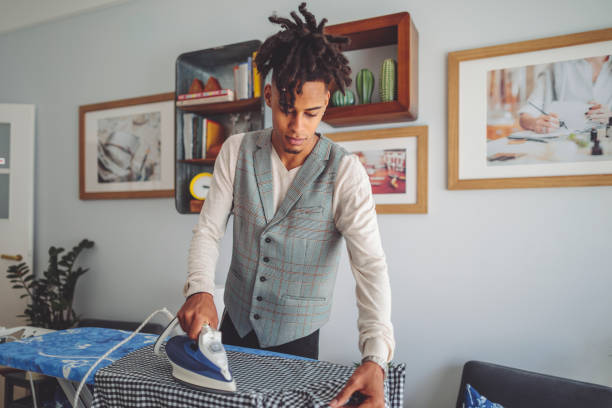 istock Young man ironing his shirt 1442797171